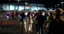 Attendees gather outside hours before Charlie Kirk’s memorial begins