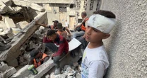 ‘My siblings are under the rubble’: Wounded boy waits at scene of Gaza airstrike