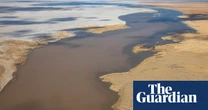 Flood waters pour into Kati Thanda-Lake Eyre in rare spectacle ‘supercharged by climate change’