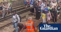 Evacuated London train passengers forced to walk along tracks on hottest day of year