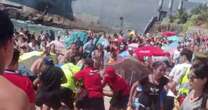 Moment 20-strong group brawl breaks out on Chile beach with one man stabbed and 4 arrested