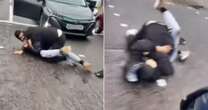 Shock moment two men locked in road rage row wrestle in middle of busy major A-road