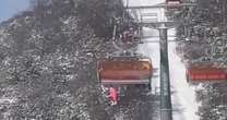 Horrifying footage shows little girl dangling from ski lift before plummeting 40ft into snow