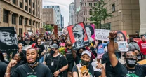 George Floyd's family march alongside hundreds to mark 'painful' year since his death