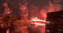 London's Albert Bridge lit up with fireworks and flares as one lands on Uber boat in dangerous scenes