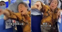 Moment cabin crew hold back pensioner after demanding passenger gives up window seat