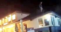 Moment yob hurls roof tiles at police during five-hour pub stand-off after booze binge