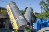 One dead as Munich freight trains crash sending carriages plunging off bridge