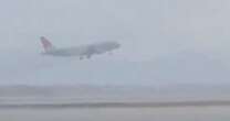 Dramatic moment pilot of packed passenger jet aborts his landing during storm