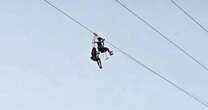 Terrified tourists stuck mid-air on mountain zipline told they're to blame for being 'too light'