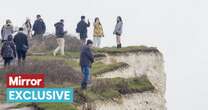 Moment tourists dice with death taking selfies on crumbling Sussex cliff edge