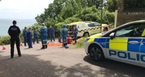 Woman escapes car crash over 100ft cliffs - only to fall another 50ft onto beach
