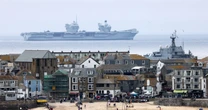 Mind-bending photos show Royal Navy warship 'flying' through air above sea