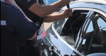 Police smash car to save dogs in 24C heat - as owner moans "you broke my window"