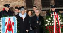 Emotional scenes as Holocaust survivors visit 'Death Wall' in Auschwitz to light candles of remembrance