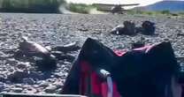 Terrifying moment pilot makes risky plane landing decision on riverbed - just yards from tourists