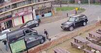 Dramatic CCTV shows police officer clinging to car as suspect speeds off