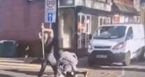 Horrifying moment men batter each other with metal poles in the middle of the road