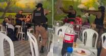 Terrifying moment on-the-run gunman with assault rifle takes hostages at child's birthday party