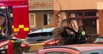 BREAKING: Car smashes into home in busy town as police tape off street