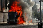 Tensions rise in Belfast as protestors set bus on fire following brutal knife attack
