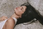 Kylie Jenner braless under completely see-through dress as she sprawls on beach