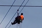 Shocking video shows moment paraglider crashes into cable car wires as he's left dangling