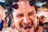 Tattoo addict with devil horns threatened in street as people want to smash his face in