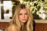 Baywatch star Brooks Nader goes completely topless while arching back on leather couch