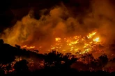 Raging wildfires force evacuations from hotels and homes in Crete as flames spread rapidly