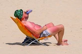 Britain’s coolest man sips a beer as he enjoys the scorching sunshine