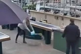 Woman pees in bucket at garden centre in front of stunned shoppers