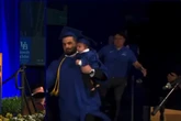 Moment student runs on stage to collect award while being chased by police