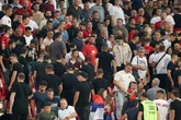 Riot police stream into stadium as England game paused after warnings of violence