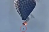 Man dies in hot air balloon fire as video shows him dangling on rope before falling
