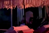 Brazen couple get frisky on deckchairs in Mykonos just metres from a busy beach club