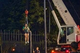 World Cup fan rescued by crane after getting stuck on 13ft fence 'trying to break in'