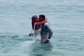 Love Island star gets her wedding dress soaking wet as she runs into the sea