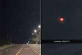 Pulsating UFO with red, green and purple lights hovers in 'craziest thing'