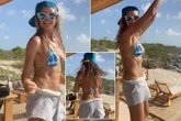 Heidi Klum jiggles boobs as she dances on beach in tiny string bikini for racy clip