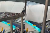 Horror moment sees fans fleeing from event as metal roof collapses on stand