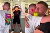 Nathan Aspinall throws 'best dart ever' at influencer with apple in his mouth