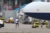 Man legs it across Heathrow Airport tarmac while planes land as staff struggle to catch up