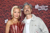 Rita Ora locks lips with husband as she wows in racy red sheer gown at premiere