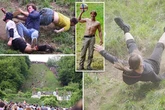 One person rushed to hospital as cheese rolling contenders fling themselves down huge hill