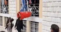 Unfortunate moment enormous clay jug falls on woman's head in Greek tradition gone wrong