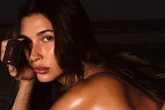 Hailey Bieber oils up for glistening bikini snaps as she flashes booty to camera