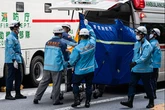 Woman dies as man falls from 12th floor and crushes her on street in major incident