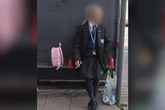 Man dressed in schoolgirl uniform with pink bag near school as kids 'not safe'