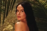 Chart-topping singer undresses in jungle and grabs boobs for saucy video